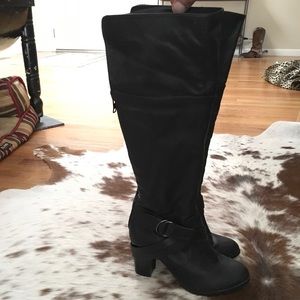 Black high heeled zip up boots